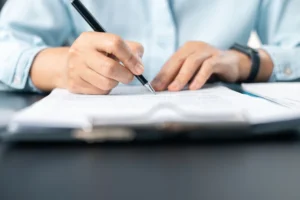 Close up of business woman signing legal documents